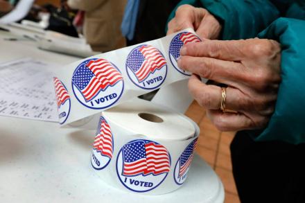 FILE PHOTO hand holding voter stickers
