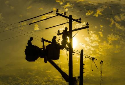 STOCK PHOTO Men Working On Power Lines.