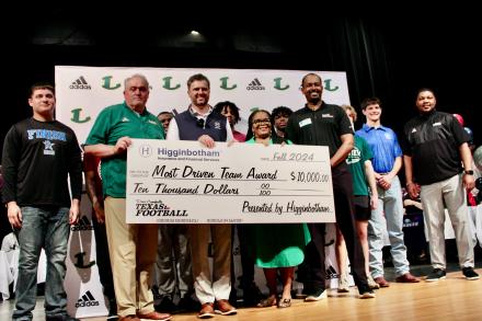 Group of Longview High School representatives holding check.