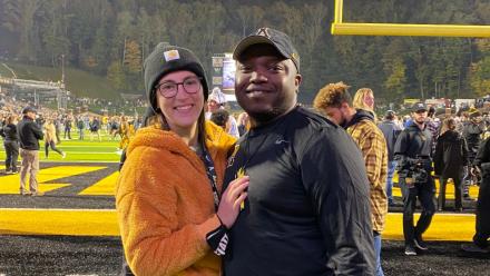 coach standing with wife