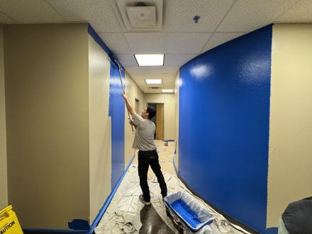 A volunteer paints Bailey