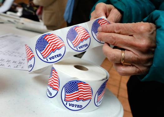 FILE PHOTO hand holding voter stickers