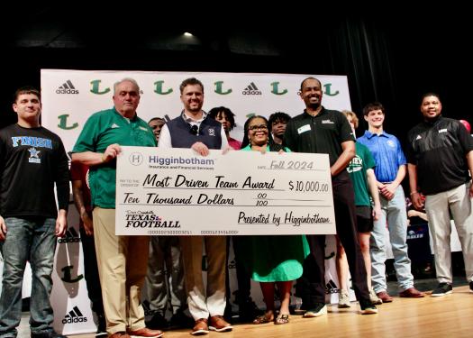 Group of Longview High School representatives holding check.