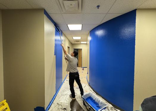 A volunteer paints Bailey