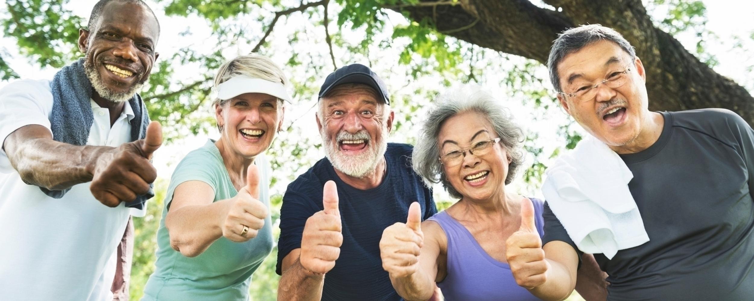 Happy retired Lobos teachers giving THUMBS UP.