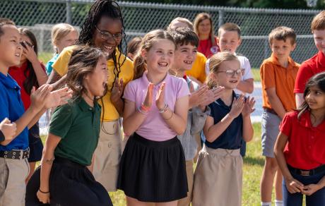 Students react to the reveal of one the winners for the city truck art contest